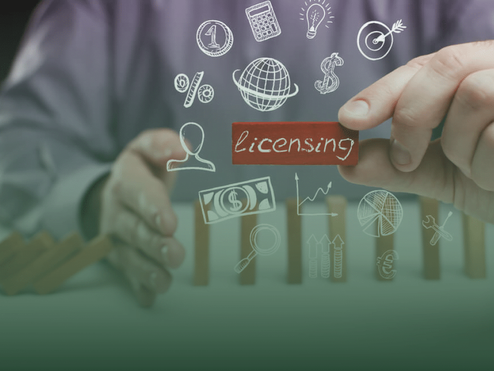 Hand assembling licensing concept blocks with business icons, highlighting the steps to secure a business license in Thailand.